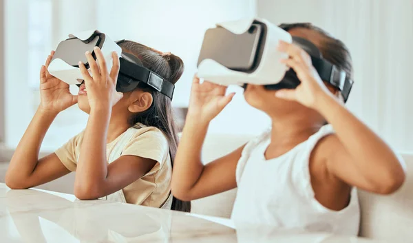 stock image Virtual reality headset, gaming and children with online tech gamer devices at home. Kids, 3d ai software environment technology and streaming metaverse video game using vr headgear in living room.