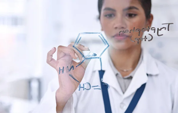 She always finds the perfect formula. an attractive young female scientist working on formulas in her laboratory