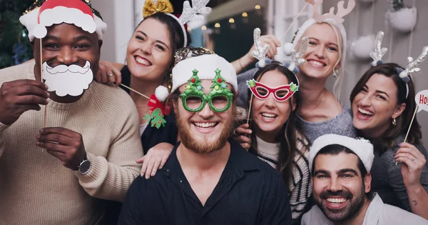 stock image The season for silliness. Portrait of a group of young friends wearing funny hats and glasses at a Christmas party