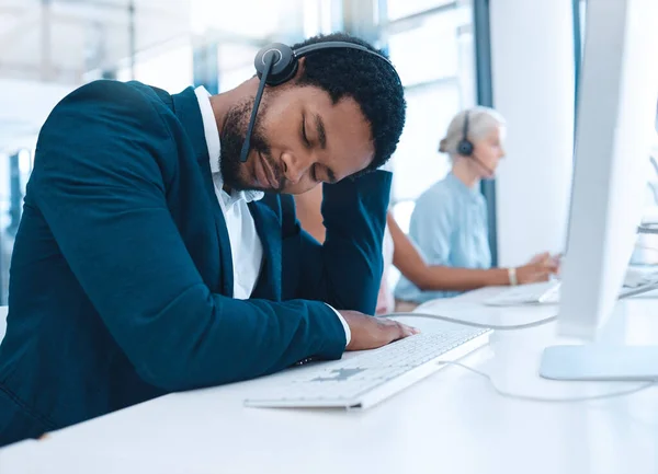 Call center burnout, sleeping man and employee exhausted after long hours, telemarketing or customer service consulting. Company office agent, help desk consultant or contact us worker tired at work.