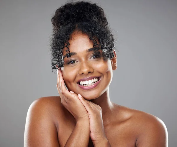 Beauty, portrait and black woman with hand pose for natural hair care advertising with smile. Happy model with healthy and shiny curly hair for cosmetic marketing with grey studio mockup