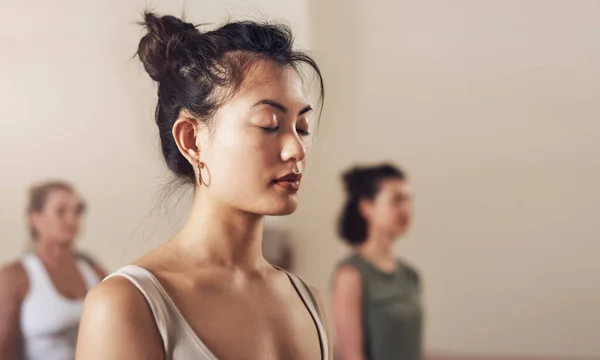 stock image Start connecting more with your inner self. an attractive young woman meditating in a yoga class