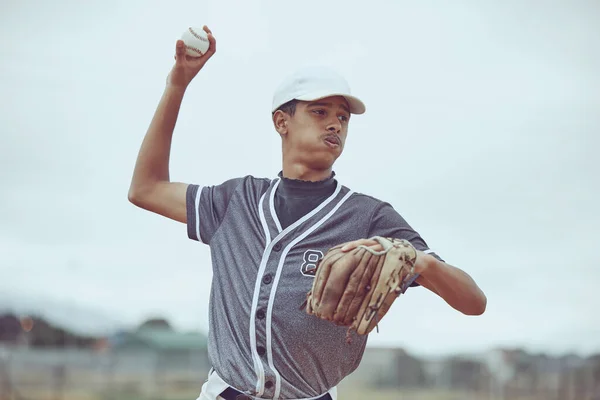 Baseball, baseball player and ball throw in baseball field in match, training game or competition. Sports, fitness and baseball pitcher man from India practice pitch outdoors for exercise or workout