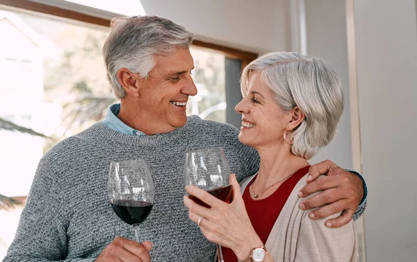 Toast to a good life. a happy mature couple having red wine together during a relaxing day at home