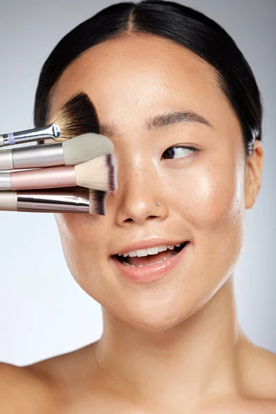 Makeup, brush and beauty woman for asian skincare glow, cosmetics or product advertising with studio mock up. Dermatology, skin care and artist or Japanese model cover eye for marketing mockup.