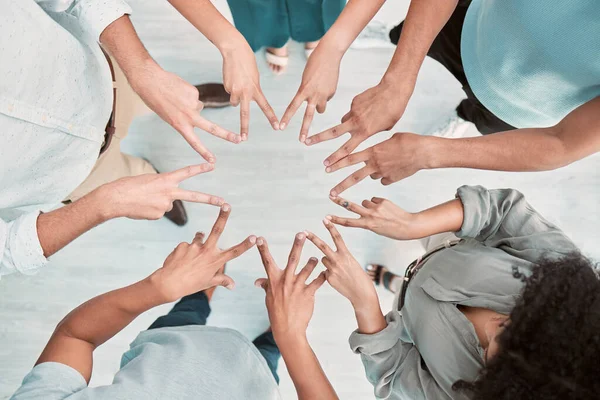 Business people, hands and peace in support above for trust, unity or teamwork for company goals at the office. Hand of group in corporate solidarity, partnership and star symbol with fingers at work.