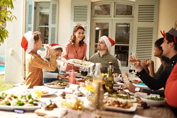 Family is the best part of Christmas. a happy family having Christmas lunch together
