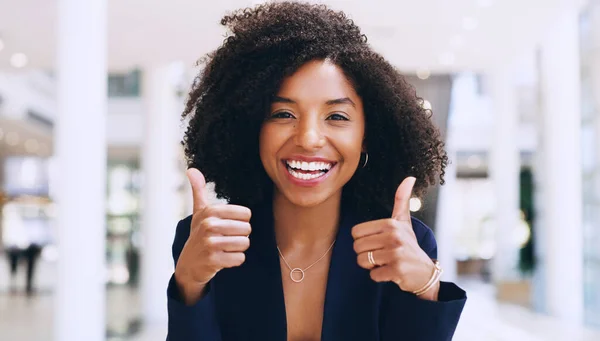 stock image Were going to do great together. Cropped portrait of an attractive young businesswoman standing with a thumbs up gesture while in the office during the day