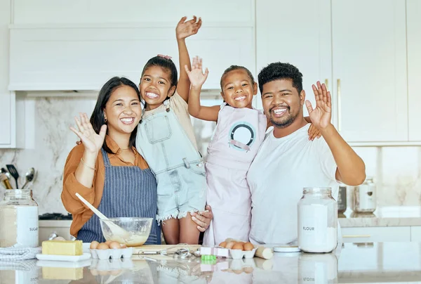Family, love and baking together in kitchen with smile, happy and wave with ingredients on counter or table. Portrait of girl kids, mother and father enjoy cooking or bake while bonding in home.