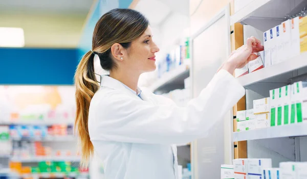 stock image I sold so many of this today. a female pharmacist working in a chemist
