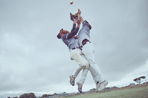 Sports, action and a men catch baseball, jump in air with ball in baseball glove. Energy, sport and catch, baseball player on the field or pitch during game, professional athlete in game or match.