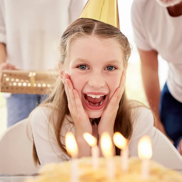 Happy, girl and birthday surprise by candles in celebration, happiness and wow facial expression at home. Portrait of female teenager celebrating special day with family by cake with smile for wish.