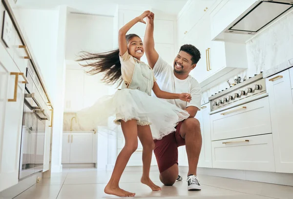 Love, dancing and father with girl in kitchen bonding, having fun and playing together. Family, affection and happiness in Indian dad with child dance, spin and relax in family home enjoying weekend.