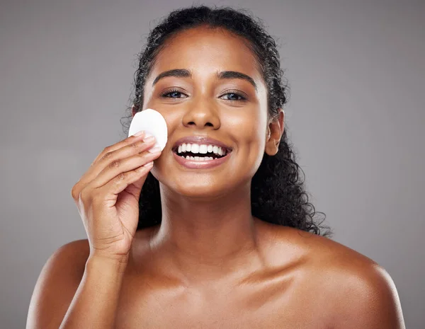 Skincare, beauty and portrait of black woman with cotton pad to cleanse face. Beauty products, facial and girl clean makeup, cosmetics and skincare products for healthy skin, wellness and body care.