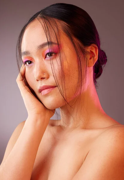 Futuristic, asian and makeup of woman for beauty, cosmetics and skincare color in studio mock up and neon light. Skin care, future and vaporwave model with Japanese or Korea dermatology health mockup.