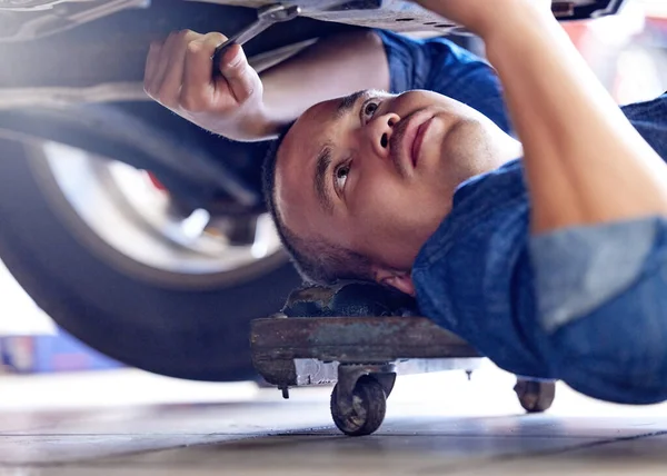 Mechanic, wrench or fixing car in mechanical engineering workshop, vehicle manufacturing industry or garage store. Thinking man, auto motor worker and service employee in transport repair maintenance.
