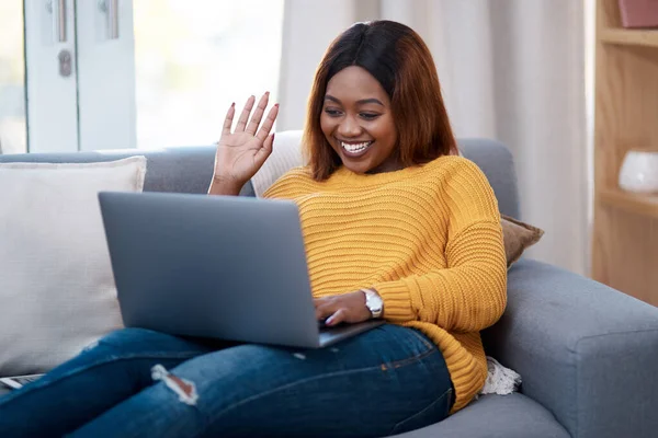 stock image Home is my happy place. a young woman using her laptop while relaxing on the sofa at home