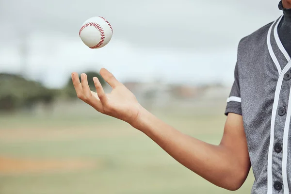 Baseball, hand and athlete holding a ball on an outdoor field for a match or sports training. Softball, sport and man playing with equipment for exercise before a game or practice on pitch at stadium.