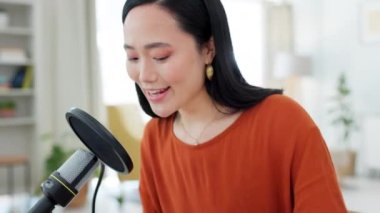 Podcast, mikrofon ve Asyalı bir sunucuyla canlı yayında laptopta kayıt yaparken ya da yayınlarken. Kendi stüdyosunda konuşan bir kadın flama ile nüfuzlu, medya ve radyo..