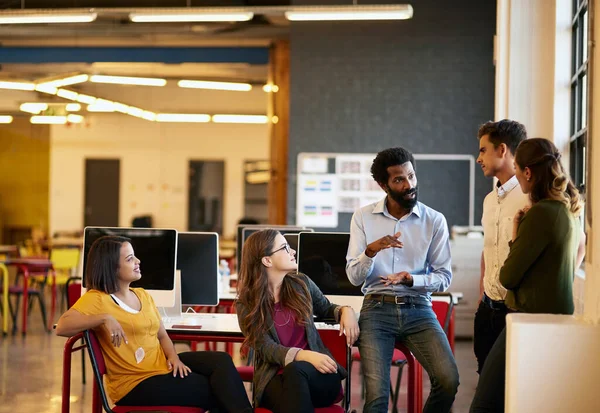 stock image I want us to big this time. colleagues having a discussion in a modern office