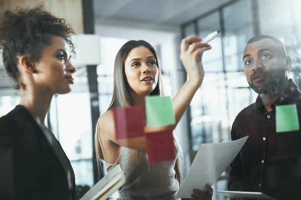 stock image Putting the plan into focus. a group of young businesspeople brainstorming in a modern office