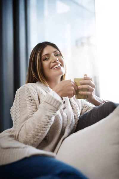 stock image Enjoying coffee and my own company. a young woman enjoying a cup of coffee while relaxing at home