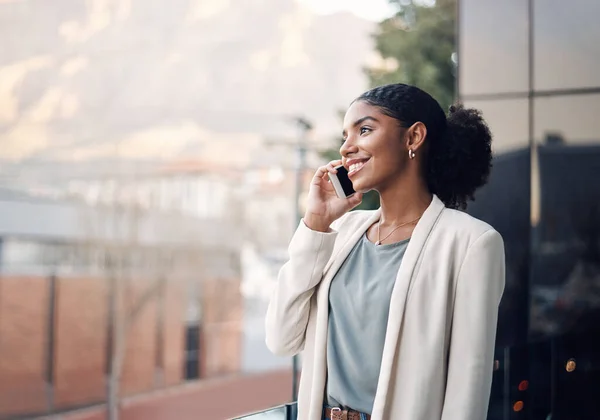 stock image Success called, she answered. a young businesswoman using a mobile phone out on the balcony of a modern office