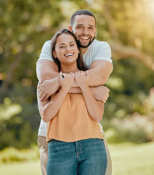 stock image Young couple hugging in park, garden and nature for love, care and romantic date together outdoors in Colombia. Portrait of smile, laughing and relax couple in happy marriage and joyful relationship.