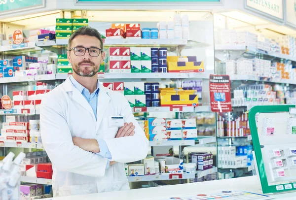 Tell me your symptoms and Ill give your the remedy. Portrait of a confident mature pharmacist working in a pharmacy