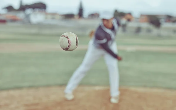 Baseball, sports and athlete pitching with a ball for a match or training on outdoor field. Fitness, softball and pitcher practicing to throw with equipment for game or exercise on a pitch at stadium.