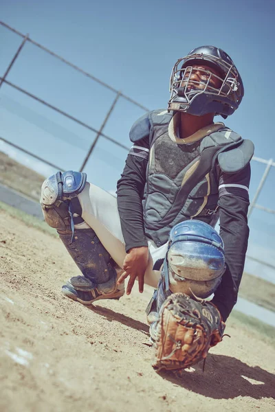Sports, baseball and catcher ready in a game, match or training on outdoor baseball field. Fitness, exercise and baseball player with focus, concentration and determination to win baseball game.
