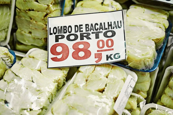 Such a good price for something that good. a bunch of packaged pieces of fish stacked on top of each other to be sold at a market during the day