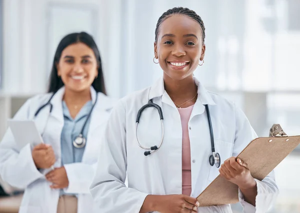 Healthcare, women and doctors with patient chart on clipboard in hospital or clinic. Happy black woman doctor, medical partnership and insurance documents, diversity and leadership in health care