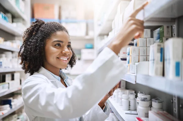 Shes got what you need. an attractive young female pharmacist working in a pharmacy