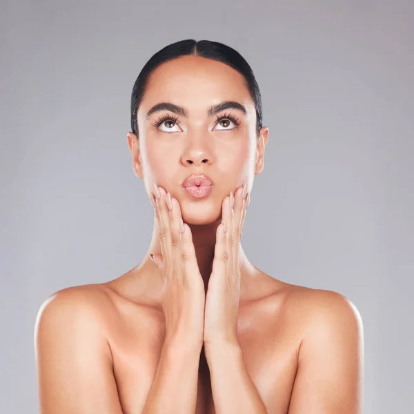 Skincare, beauty and surprise face of a woman from Spain with healthy, wellness and glowing skin. Female model hands after cosmetic, health dermatology and botox treatment or plastic surgery.