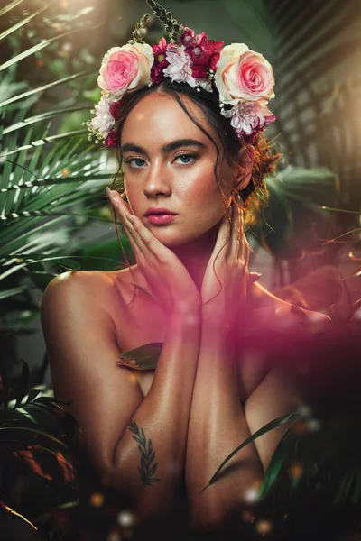 Crown, flower and portrait of woman in studio for skincare, beauty and product from nature, wellness and makeup. Jungle, rose and face of girl model with leaf, plant and creative forest aesthetic.