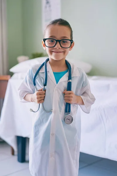 Playing doctor is my favorite thing to do. an adorable little girl dressed as a doctor