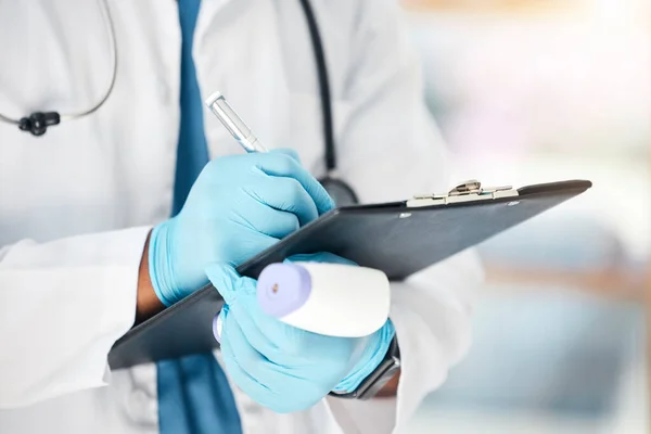 stock image Covid doctor, thermometer and writing notes, information and healthcare planning, research and test results of fever, sick and flu check in clinic. Nurse hands, laser gun and corona virus safety risk.