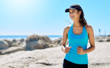 Running makes me feel healthy. a young woman out running clipart