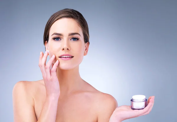 stock image Sure, my life isnt perfect, but my skincare is. a young woman applying moisturizer to her face