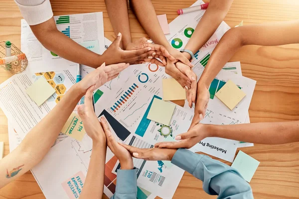 Top view, business people or circle hands in security, safety or trust with infographic documents, kpi research or target audience data. Men, women or teamwork collaboration unity in marketing office.
