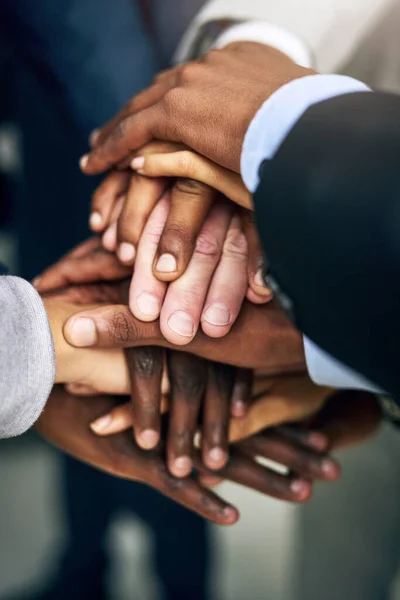 stock image Support your colleagues. High angle shot of a group of unrecognizable businesspeople joining their hands together in unity