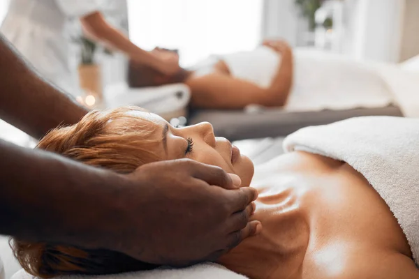 Spa, wellness and black woman getting massage with massage therapist hands and relax with stress relief. Beauty treatment salon, body therapy and relaxation, peace and calm with luxury service