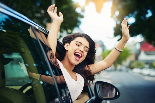 stock image Celebrating her new car. an attractive young woman celebrating her new car