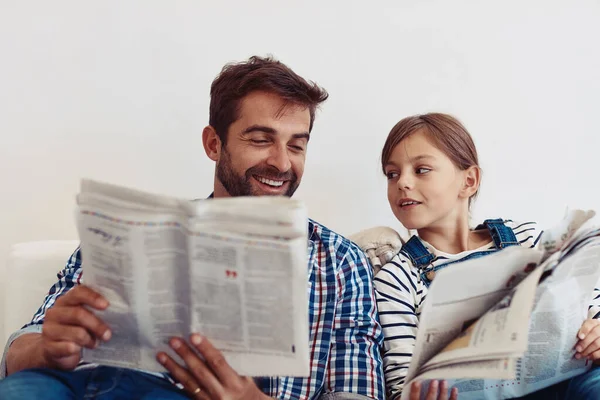 stock image How interesting is this. an adorable little girl spending time with her father at home