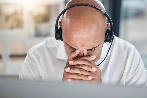 Burnout call center or consultant black man with headache for 404 computer error, financial stress or customer service with anxiety. Mental health, depression or sad fatigue hotline male employee.