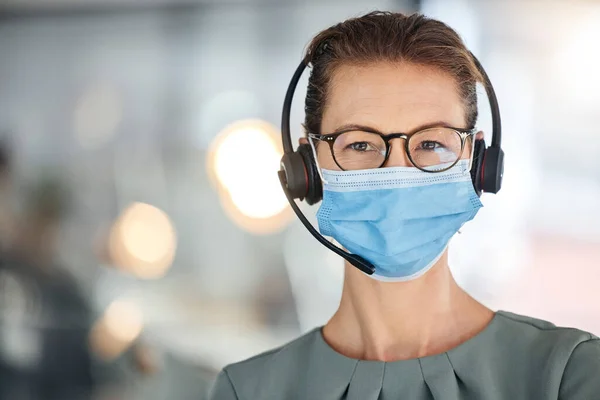 Call center, covid and portrait of woman in mask with headset for consulting in office. Crm, covid 19 compliance and mature sales agent or customer service worker in workplace following health rules