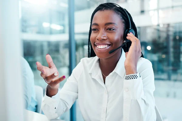 Communication, call center and black woman consulting at computer with professional customer online. Telemarketing consultant listening to internet client with smile in corporate workplace