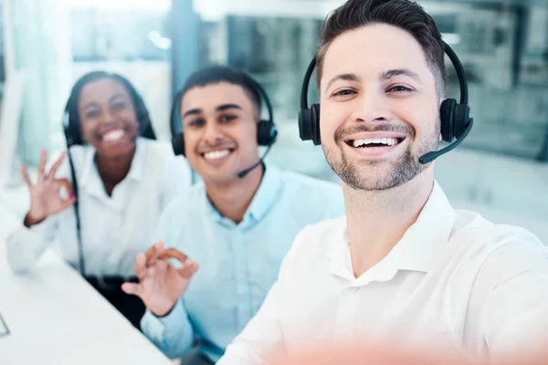Selfie, call center and employees with smile, emoji hand and teamwork in telemarketing. Crm, ecommerce and portrait of customer service team with photo, sign for success and working in collaboration.
