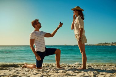 Yaz tatili için mükemmel bir yer. Genç bir adam bir yaz günü sahilde kız arkadaşına evlenme teklif ediyor.